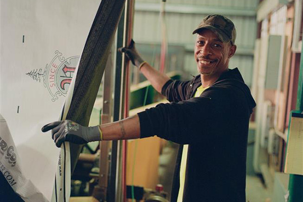 A lumber worker smiling for a picture